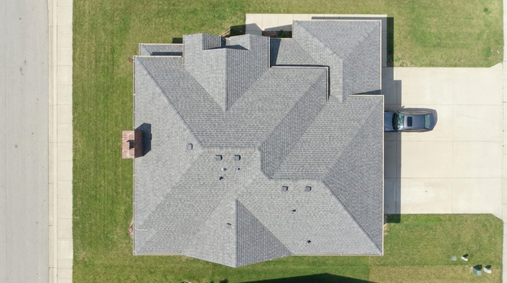 TWE Residential – Roof Inspection (Aerial) – 2560×1429-17-17 Aerial top-down view of a residential roof showing multiple roof planes and driveway